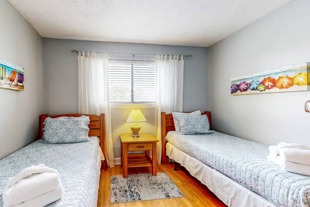 Updated coastal villa with pools, athletic courts, gym, smart TVs, AC, & W/D