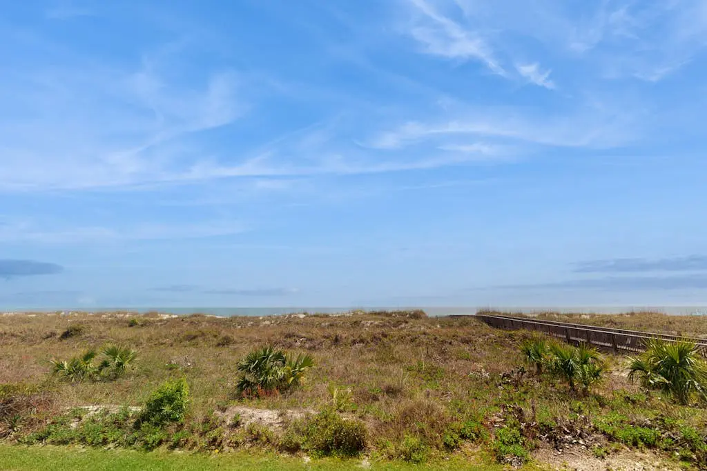 1st-floor condo near the beach with pool, tennis, balcony, gym, streaming, W/D