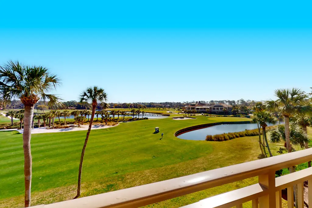 Coastal resort-style villa with pool, golf, & balcony - W/D, AC, & dog-friendly