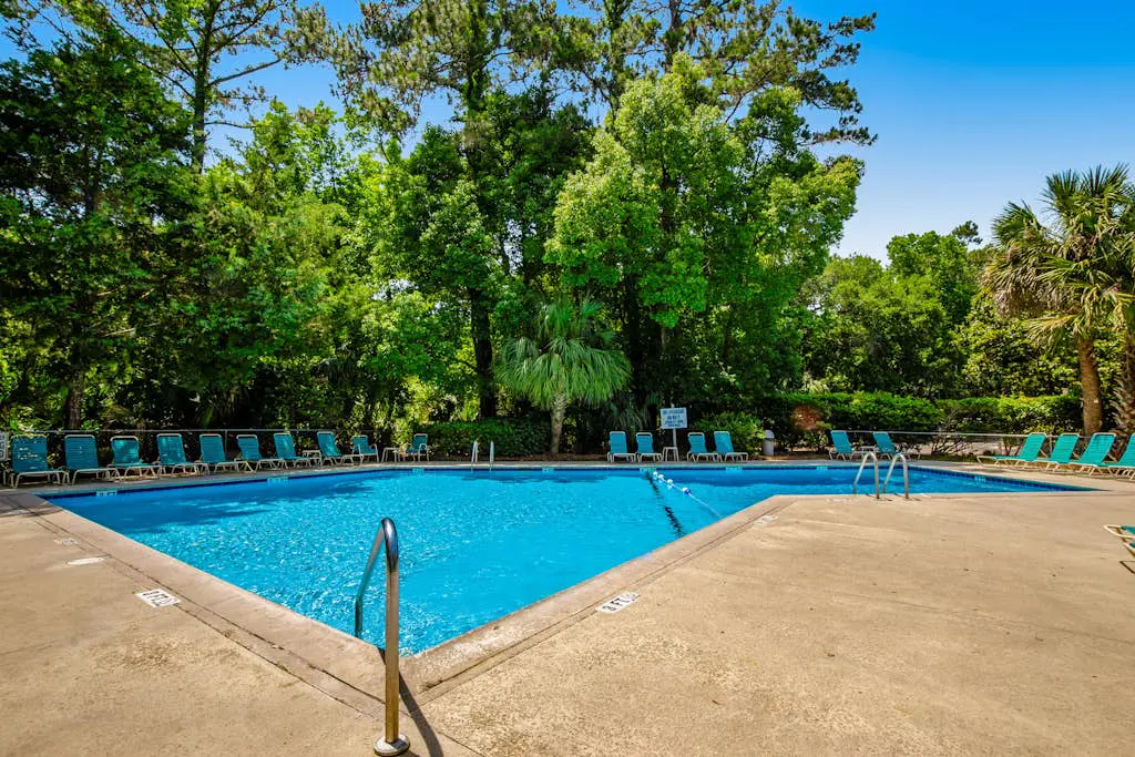 Coastal resort-style villa with pool, golf, & balcony - W/D, AC, & dog-friendly