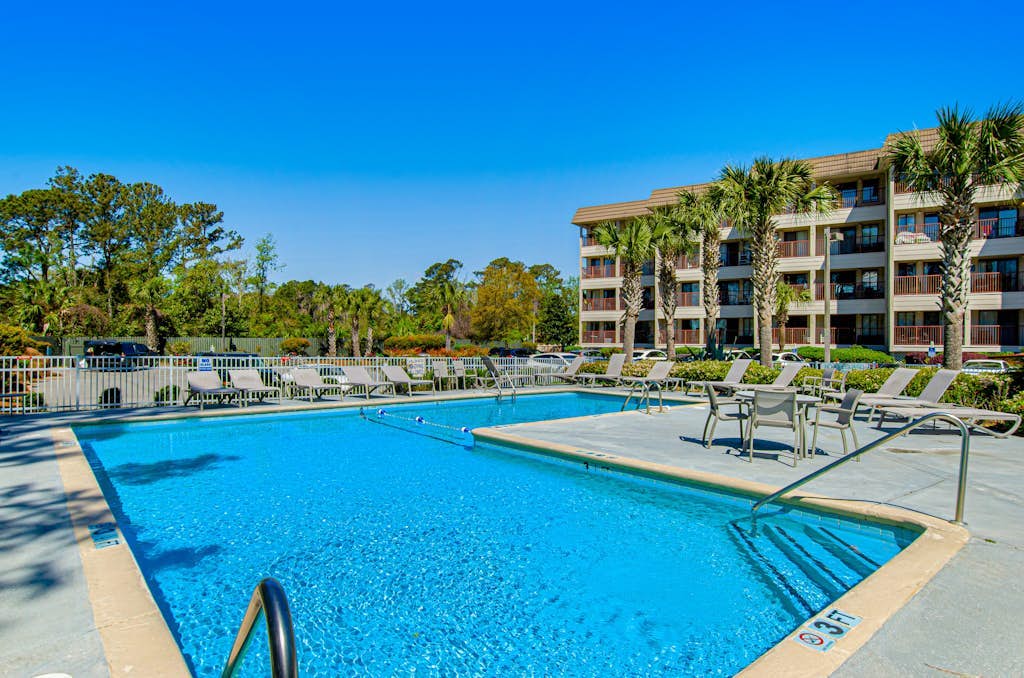 1st floor condo with  balcony, pools, tennis & close to beach