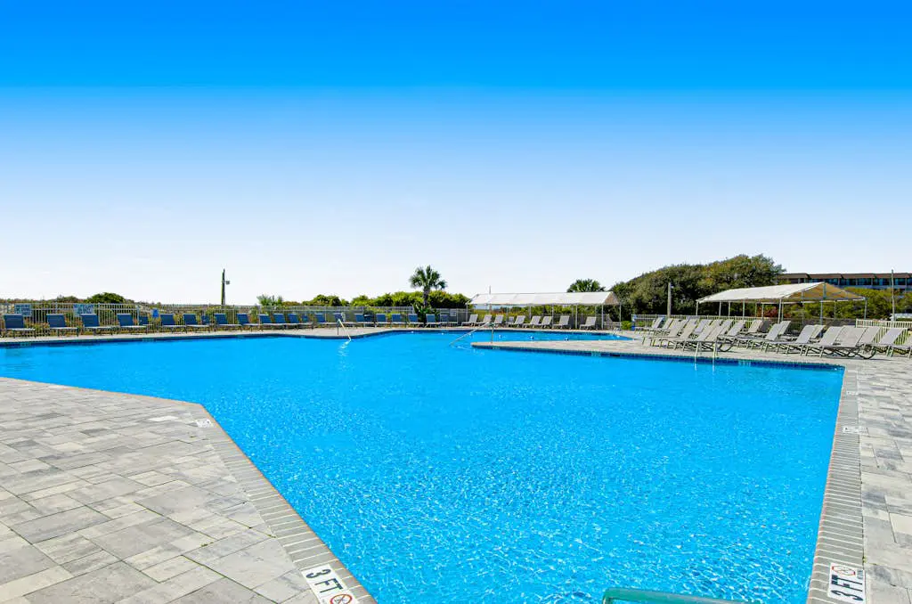 1st floor condo with  balcony, pools, tennis & close to beach