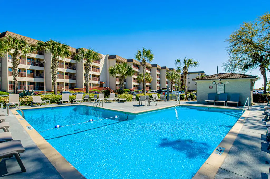 1st floor condo with  balcony, pools, tennis & close to beach