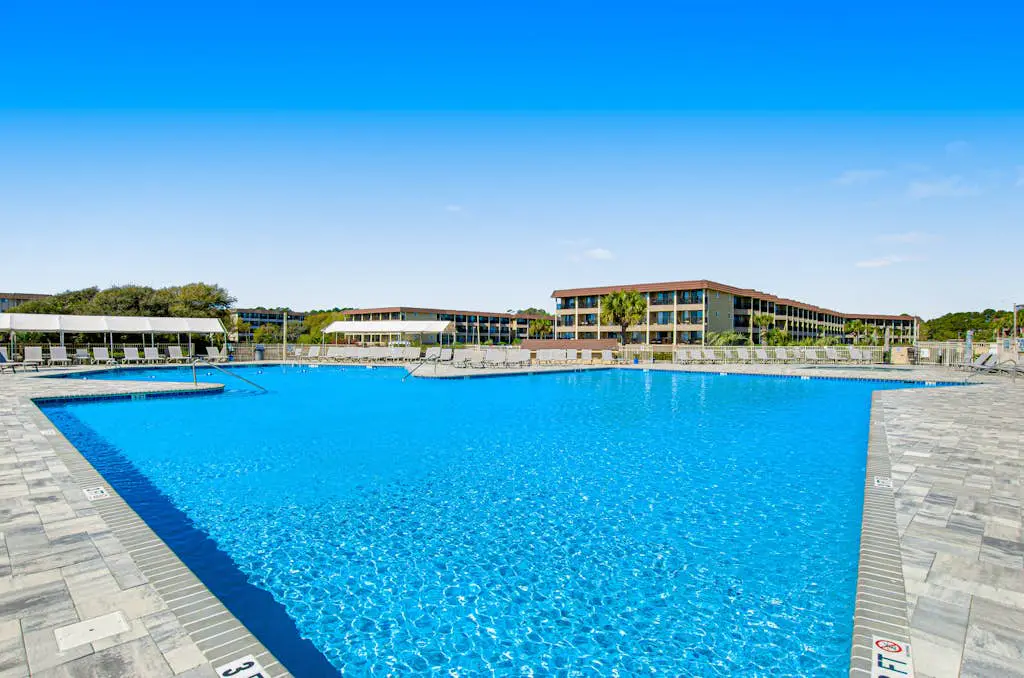 1st floor condo with  balcony, pools, tennis & close to beach
