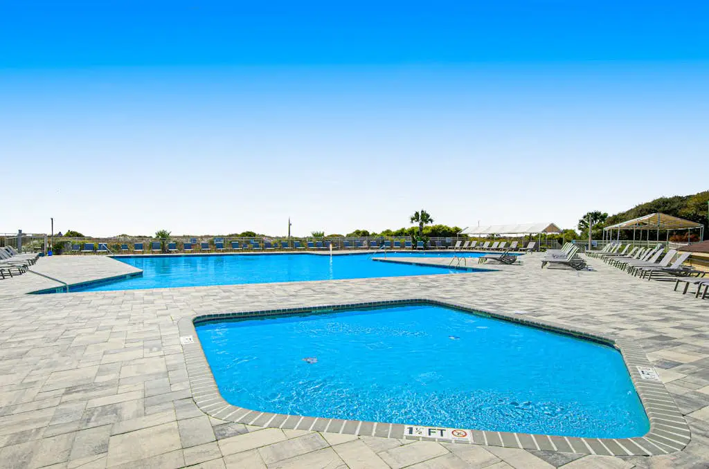 1st floor condo with  balcony, pools, tennis & close to beach