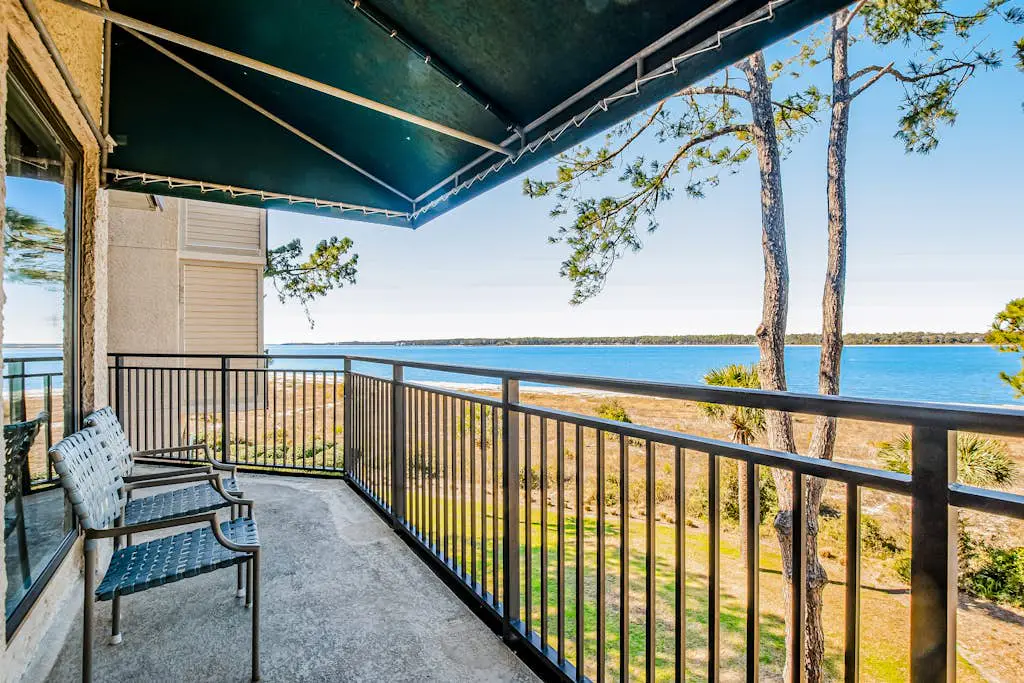 Beachfront condo with large furnished balcony, pool & beautiful views