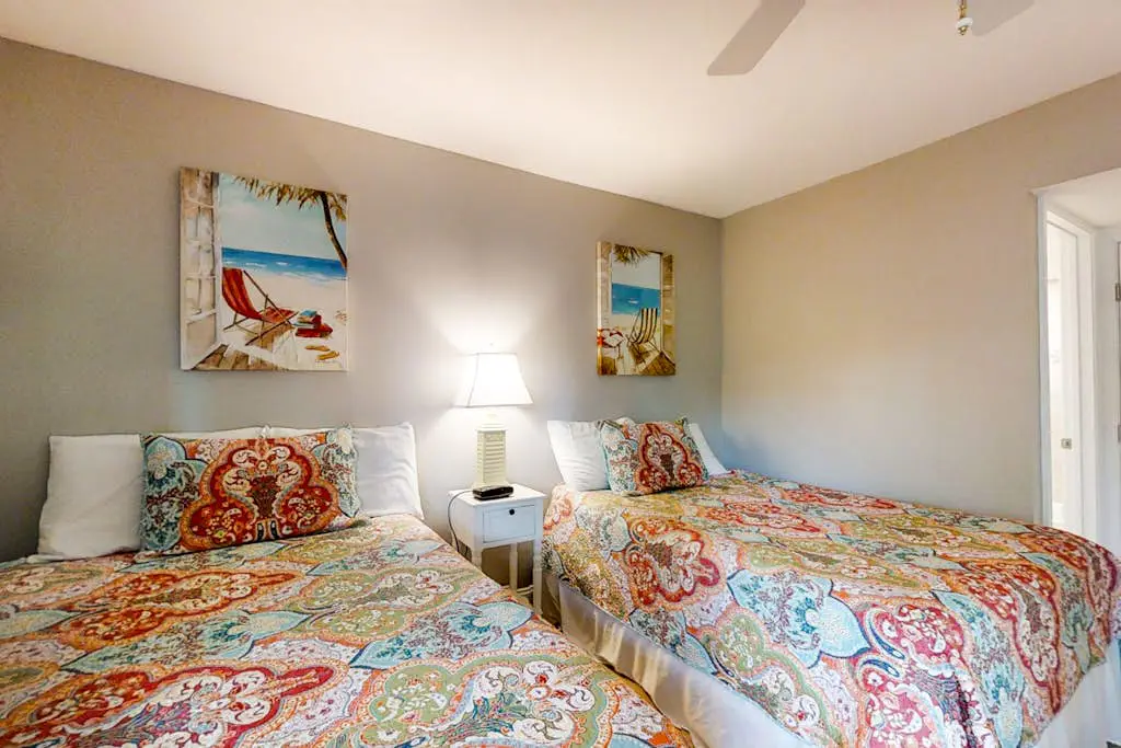 Bright, charming condo with screened porch, shared pool, and easy beach access
