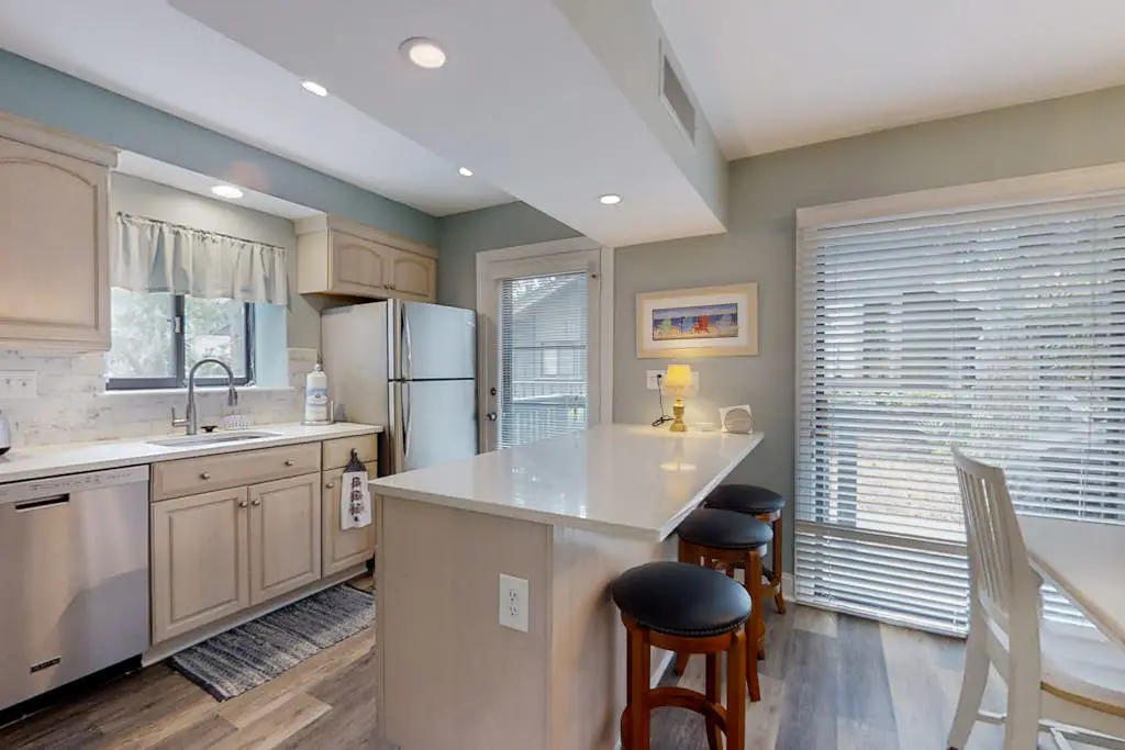 Bright, charming condo with screened porch, shared pool, and easy beach access