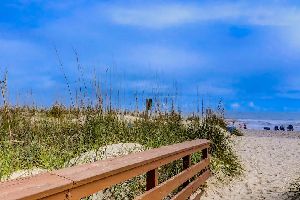 Bright, charming condo with screened porch, shared pool, and easy beach access