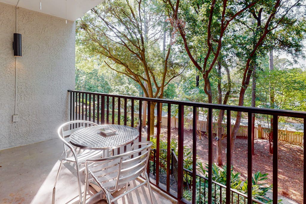 Second-floor condo with balcony, shared outdoor pool, central AC