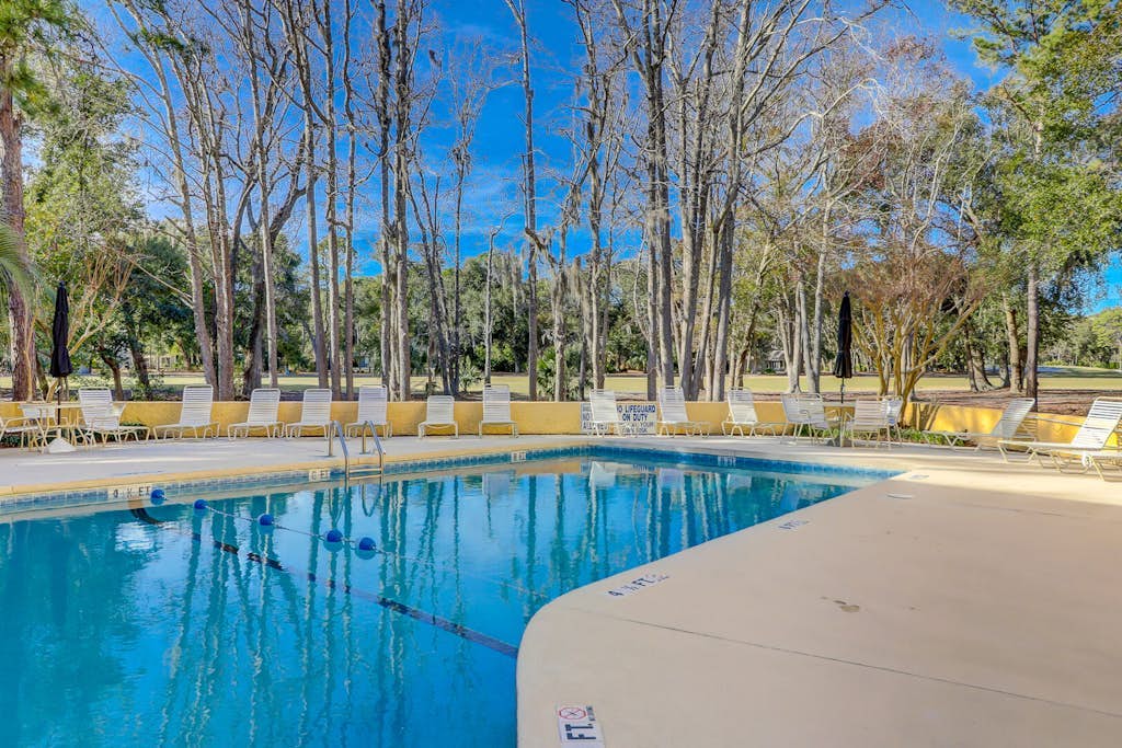 Second-floor condo with balcony, shared outdoor pool, central AC