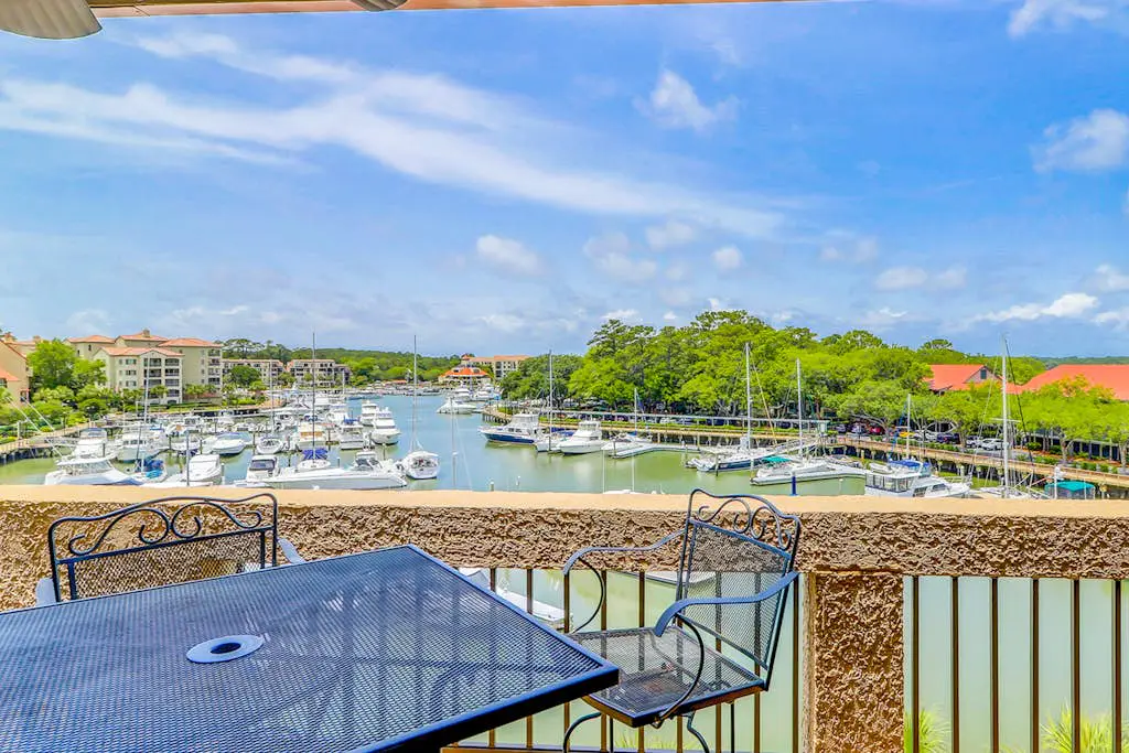 Penthouse living at Shelter Cove Marina with balcony, harbor view, pool & tennis