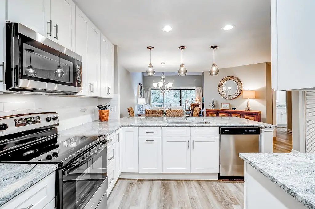 Sun-kissed bliss at Colonnade Club with dual suites, deck, shared pool, hot tub