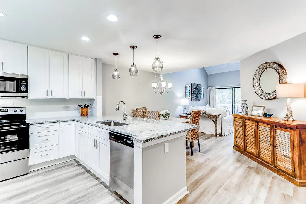 Sun-kissed bliss at Colonnade Club with dual suites, deck, shared pool, hot tub