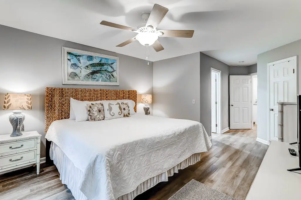 Sun-kissed bliss at Colonnade Club with dual suites, deck, shared pool, hot tub