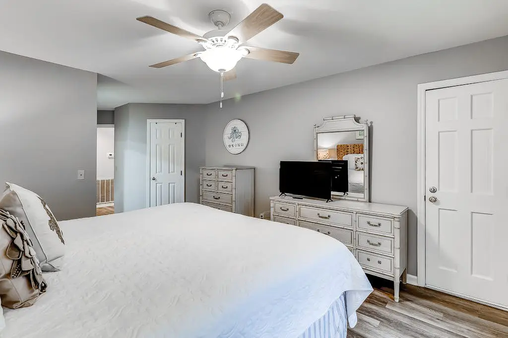 Sun-kissed bliss at Colonnade Club with dual suites, deck, shared pool, hot tub