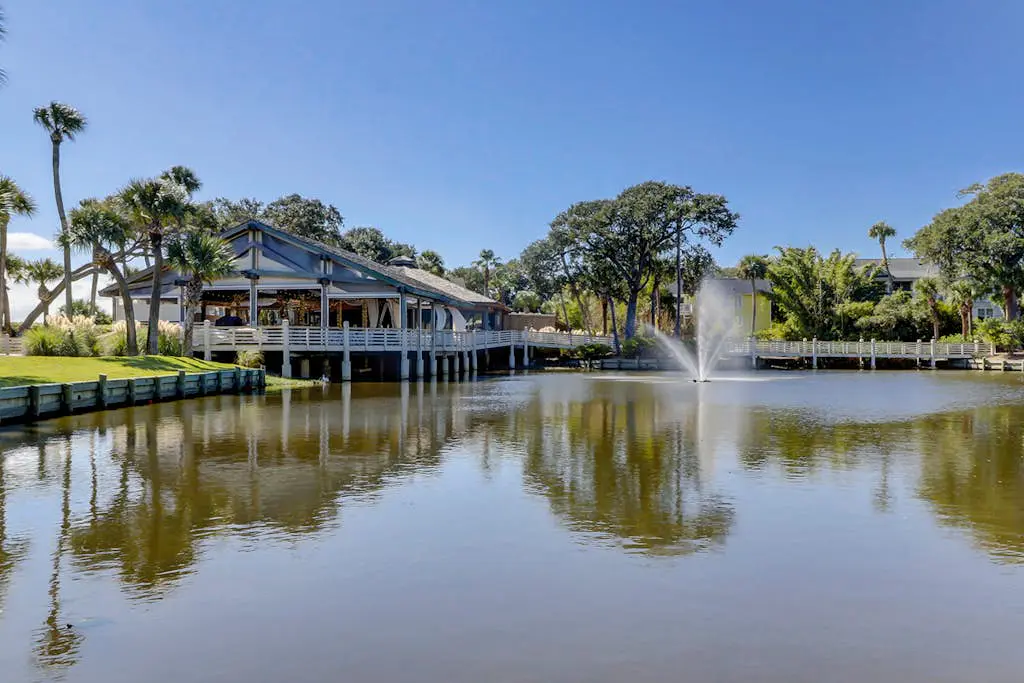 Sun-kissed bliss at Colonnade Club with dual suites, deck, shared pool, hot tub