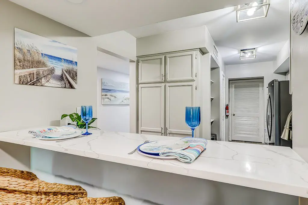 4th-floor villa with balcony, beach access, outdoor pool, & grills