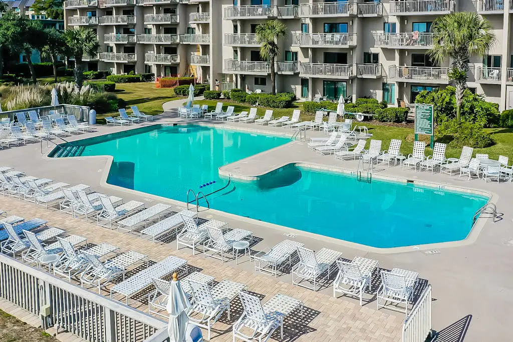 4th-floor villa with balcony, beach access, outdoor pool, & grills