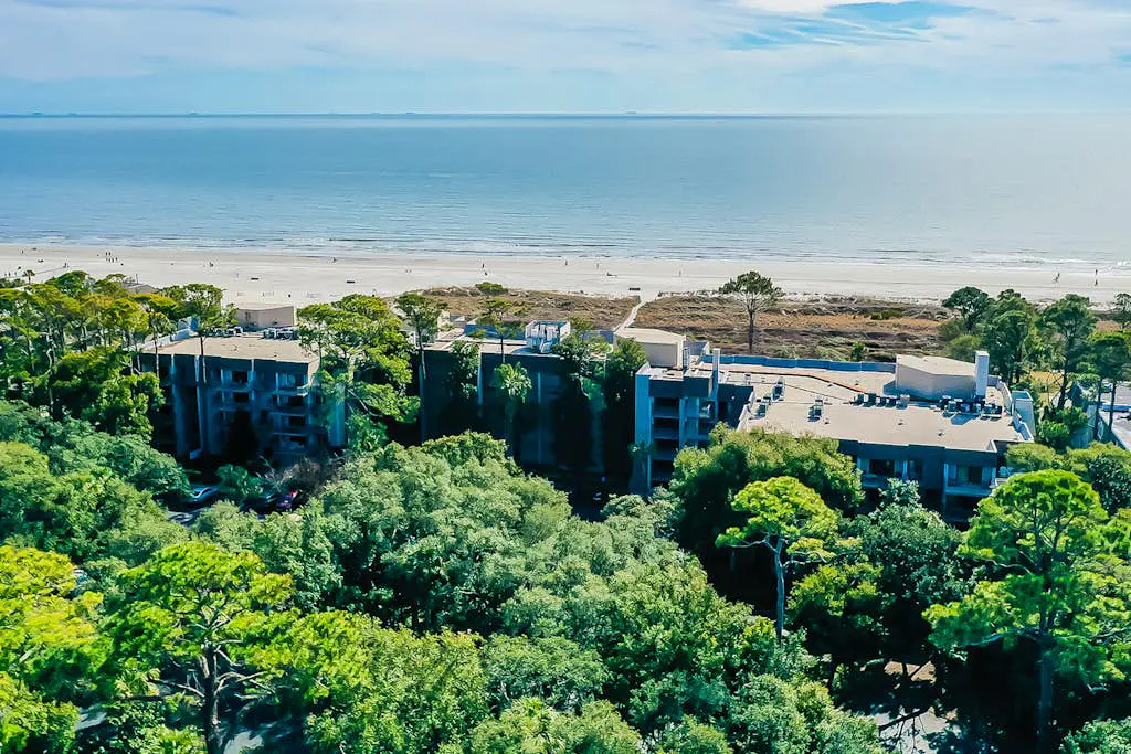 4th-floor villa with balcony, beach access, outdoor pool, & grills