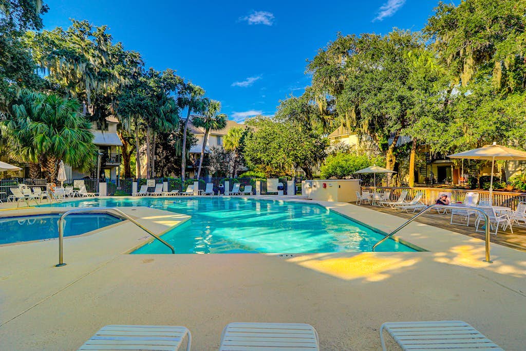 Ideally located island gem with an outdoor pool, full kitchen, & balcony