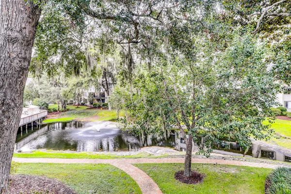 Ideally located island gem with an outdoor pool, full kitchen, & balcony