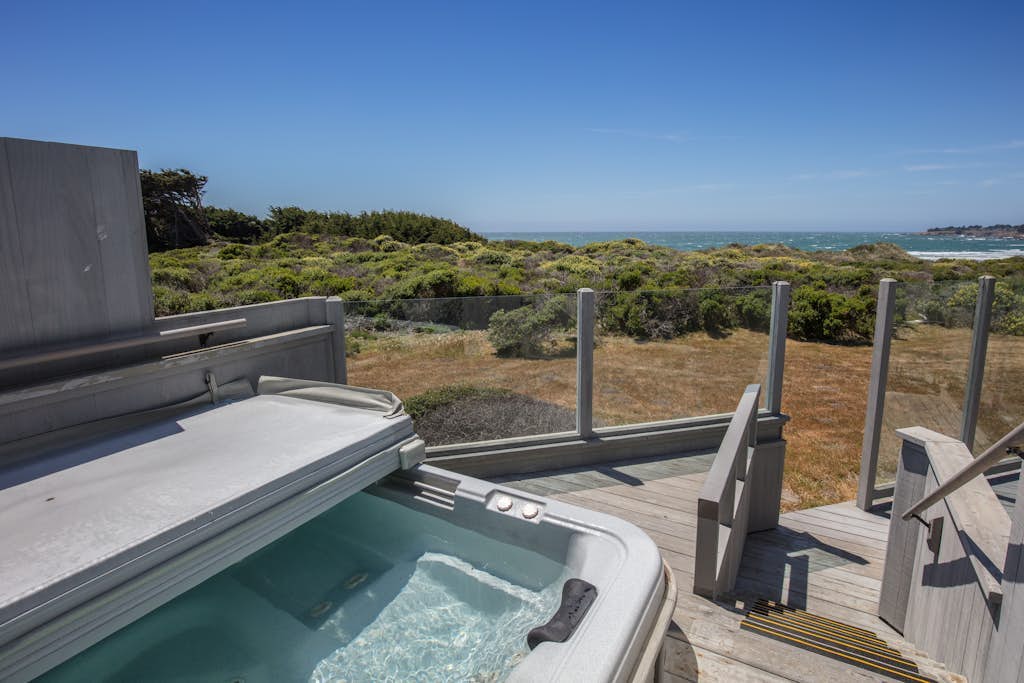 Perched on the bluffs where the Sonoma Coast meets the sky, this home delivers drama. Soak in the hot tub as the sun dips below the Pacific. A warm fire and ocean views anchor cozy evenings in. Room for 6 in this 3-bedroom home. Sea Ranch community pools, tennis courts, and the Lodge are nearby. Architecture, nature, and the Pacific -- Sea Ranch has it all. Cormorants dive and otters float just offshore -- nature's channel plays 24/7 from the windows.