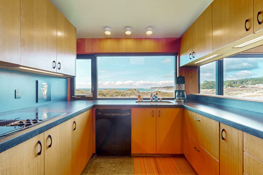Perched on the bluffs where the Sonoma Coast meets the sky, this home delivers drama. Soak in the hot tub as the sun dips below the Pacific. A warm fire and ocean views anchor cozy evenings in. Room for 6 in this 3-bedroom home. Sea Ranch community pools, tennis courts, and the Lodge are nearby. Architecture, nature, and the Pacific -- Sea Ranch has it all. Cormorants dive and otters float just offshore -- nature's channel plays 24/7 from the windows.
