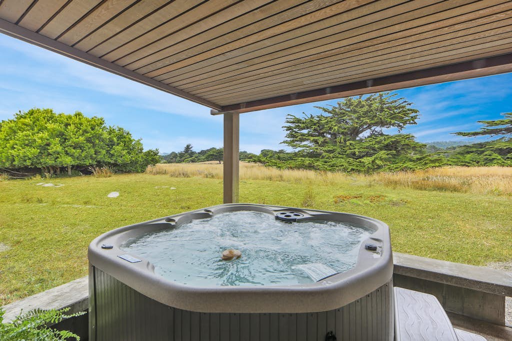 Where the forest opens to coastal meadows and the shimmer of the Pacific beyond. Soak in the hot tub with views of the hills and golf course as the sun dips below the Pacific. Curl up by the fireplace as fog rolls in off the Pacific. Room for 6 in this 3-bedroom home. Near the heated community pool. The Sonoma Coast's best-kept secret is waiting for you. The light here shifts by the hour -- silver mornings, gold afternoons, pink-and-orange sunsets. Morning fog and afternoon sun create a rhythm you'll settle into by day two.