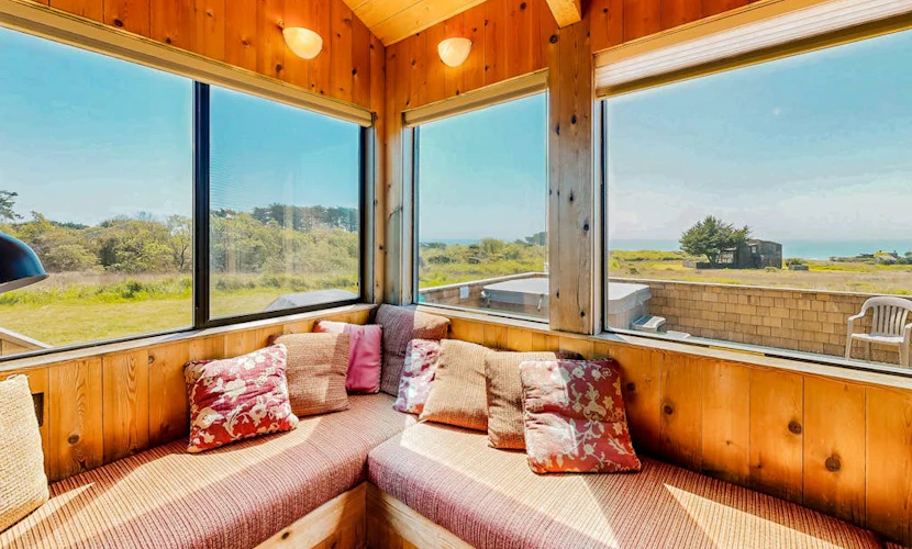 From the living room to the deck, the Pacific is always in view at this coastal home. End the day in your private hot tub with the ocean as your soundtrack. Bring your pup -- dogs love the bluff trails here. Room for 8 in this 4-bedroom home. Sea Ranch community pools, tennis courts, and the Lodge are nearby. Architecture, nature, and the Pacific -- Sea Ranch has it all. Pelicans glide past the windows, and on clear days the horizon feels infinite.