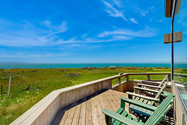 Open the door to panoramic Pacific views and endless coastal sunsets. Soak in the hot tub as the sun dips below the Pacific. Step outside to a deck overlooking the ocean. Room for 6 in this 3-bedroom home. Just a 7-minute walk to the heated community pool. Leave the city behind -- the only agenda here is yours. Salt air drifts through the windows as the Pacific puts on its daily show just beyond the deck. December through April, gray whales migrate along the coast -- binoculars recommended.