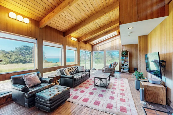 Open the door to panoramic Pacific views and endless coastal sunsets. Step outside to a deck overlooking the ocean. Room for 4 in this 2-bedroom home. Just a 6-minute walk to Black Point trails. Trails, tidepools, and two heated community pools -- all within reach. Cormorants dive and otters float just offshore -- nature's channel plays 24/7 from the windows. The wildflower meadows peak in April and May -- a photographer's dream along the bluff trails.