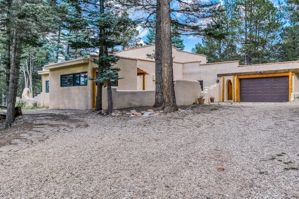Welcome to Casa Grande, an adobe-style estate tucked among the pines and aspens of Angel Fire. Five king suites, two living areas, and a gourmet kitchen give large groups room to gather and spread out. Warm by the stone fireplace, challenge each other at the arcade, then soak in the private forest-view hot tub under the stars. Whether you are here for ski days or a summer mountain reset, this secluded retreat is built for unforgettable family gatherings.