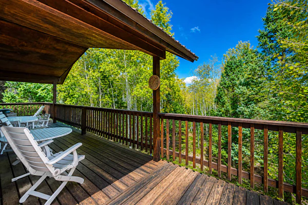 Welcome to Trailhead Retreat, a secluded Angel Fire cabin tucked into three private acres of aspens and pines with hiking trails right outside the door. Unwind in the indoor hot tub and cedar sauna after a day outside, warm up by the wood-burning fireplace, and take in the forest from the wraparound deck. With three bedrooms, room for ten, and your dog welcome, it is a peaceful basecamp for trails, golf, and mountain air.