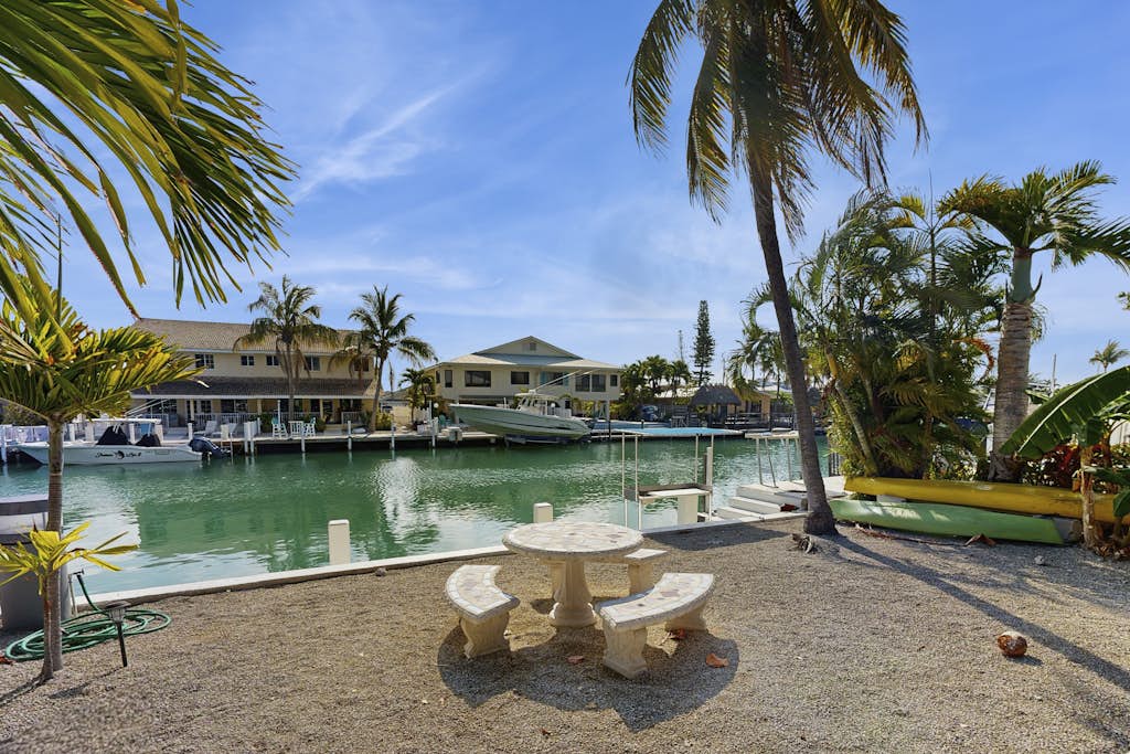 Charming canal-front home with 37-ft dock, kayaks, grill, patio & club access