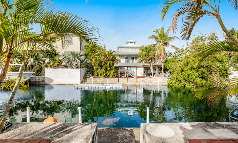 Canalside condo with private dock, boat ramp, water-view patio, central AC & W/D