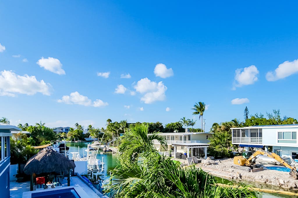 Radiant waterfront retreat with remarkable views, patio, tennis court, & grill