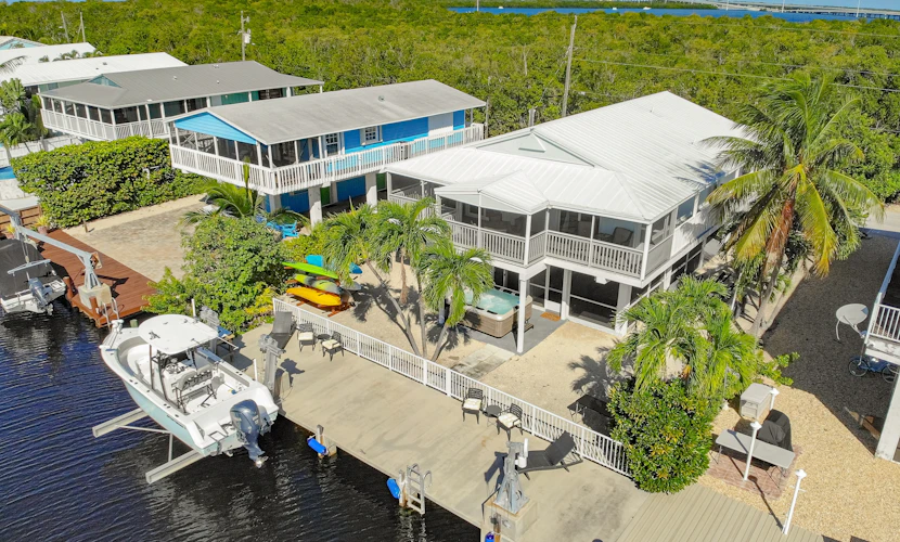 Canal-front home with private dock, hot tub, water views, kayaks, & deck