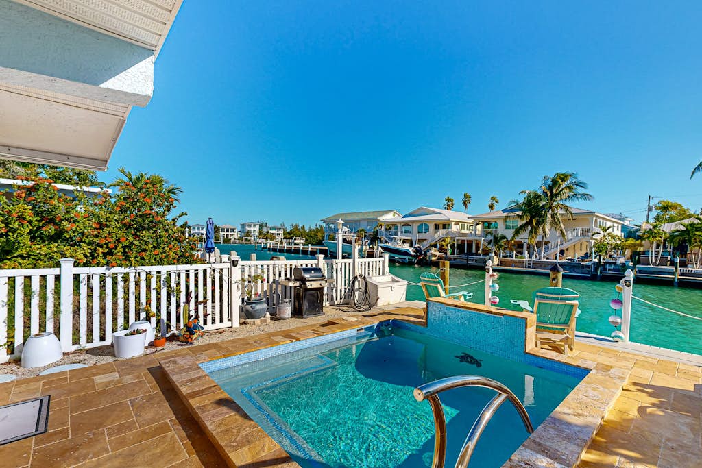 Charming canal-front cottage with private pool, dock and covered lanai