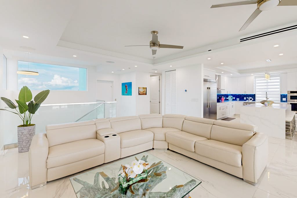 Sprawling waterfront home with pool, outdoor kitchen, game table, grill, & W/D