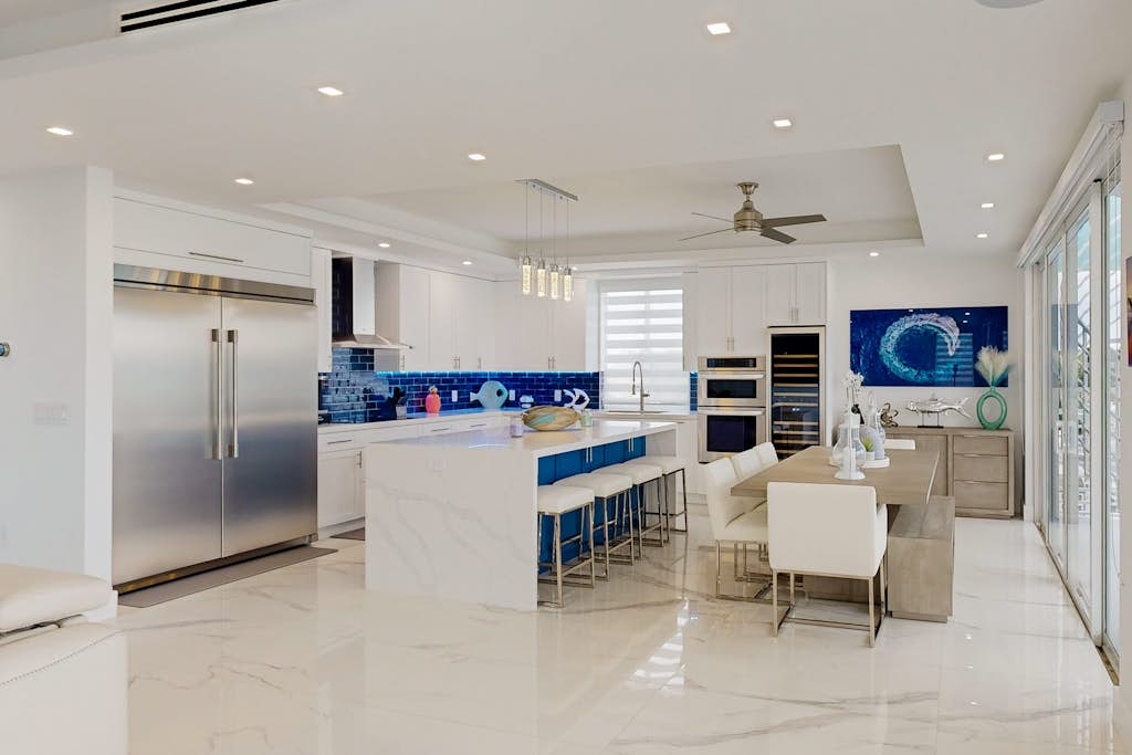 Sprawling waterfront home with pool, outdoor kitchen, game table, grill, & W/D