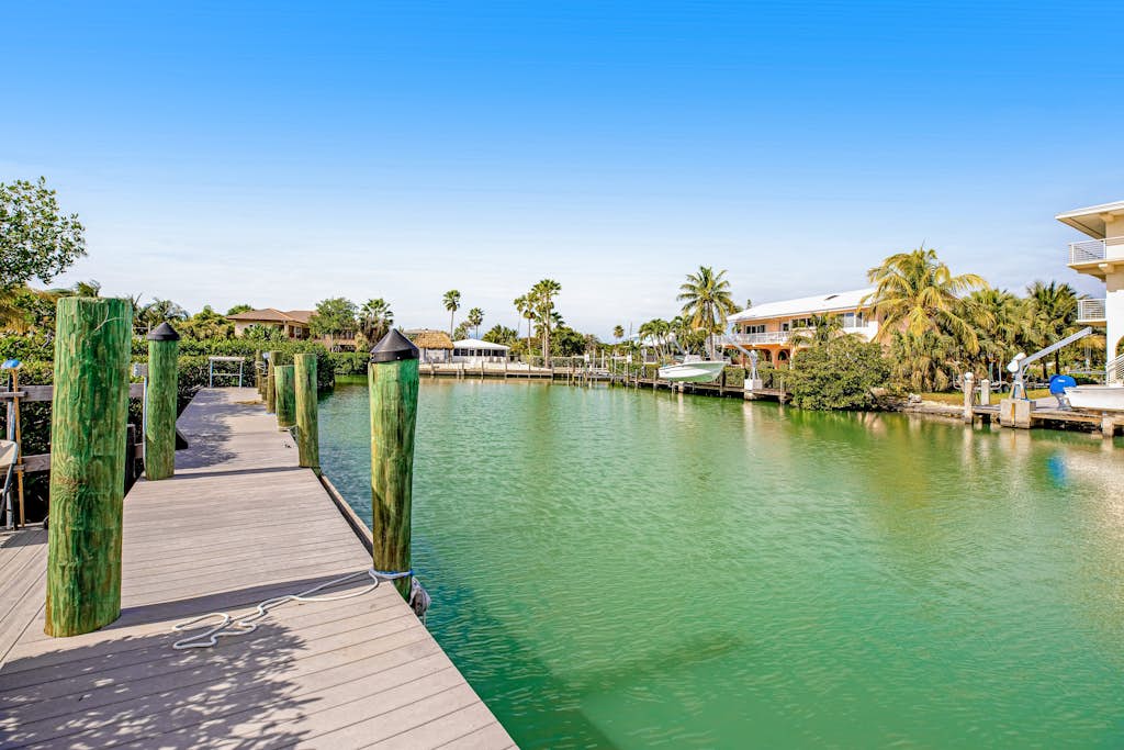 Elegant waterfront home with private pools, hot tub, & dock - walk to beach