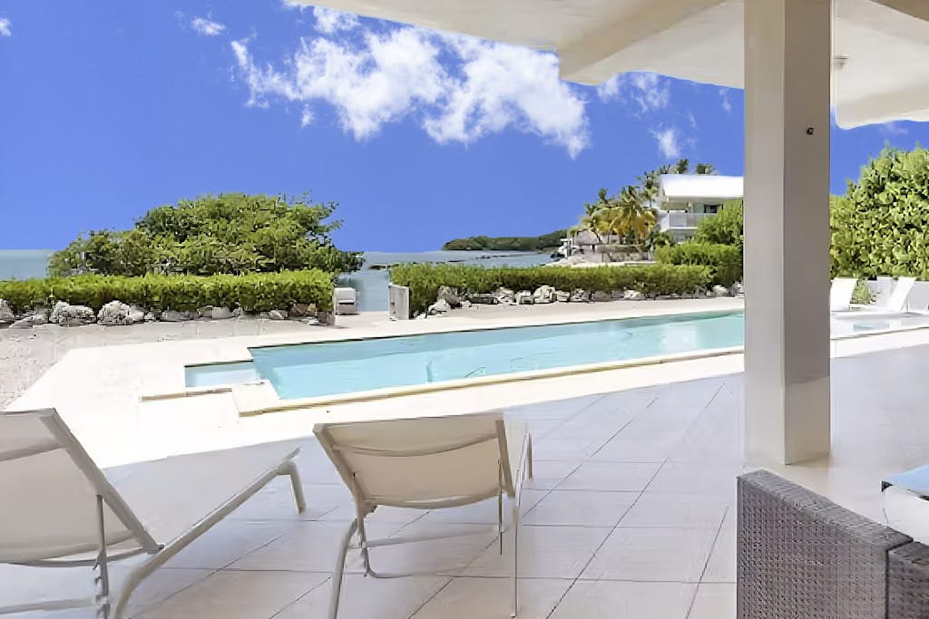 Oceanfront home with a pool, dock, grill, scenic balconies, games, W/D, & AC