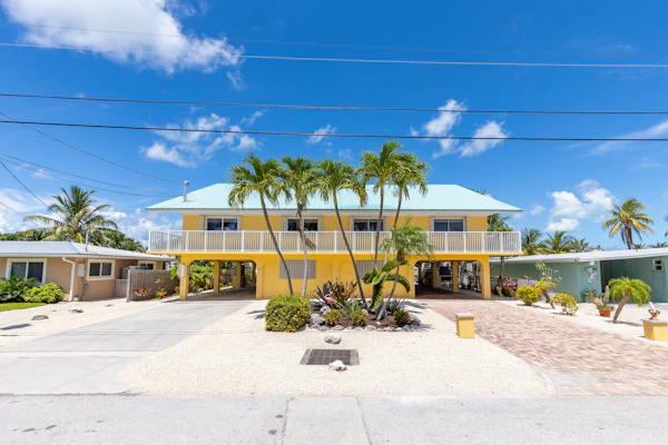 Waterfront home with dock, filet station, patio, balcony, & Cabana Club access