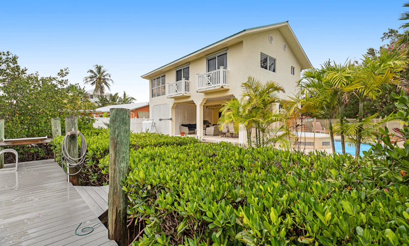 Waterfront hideaway with dock, pool & inviting patio - walk to Sombrero Beach