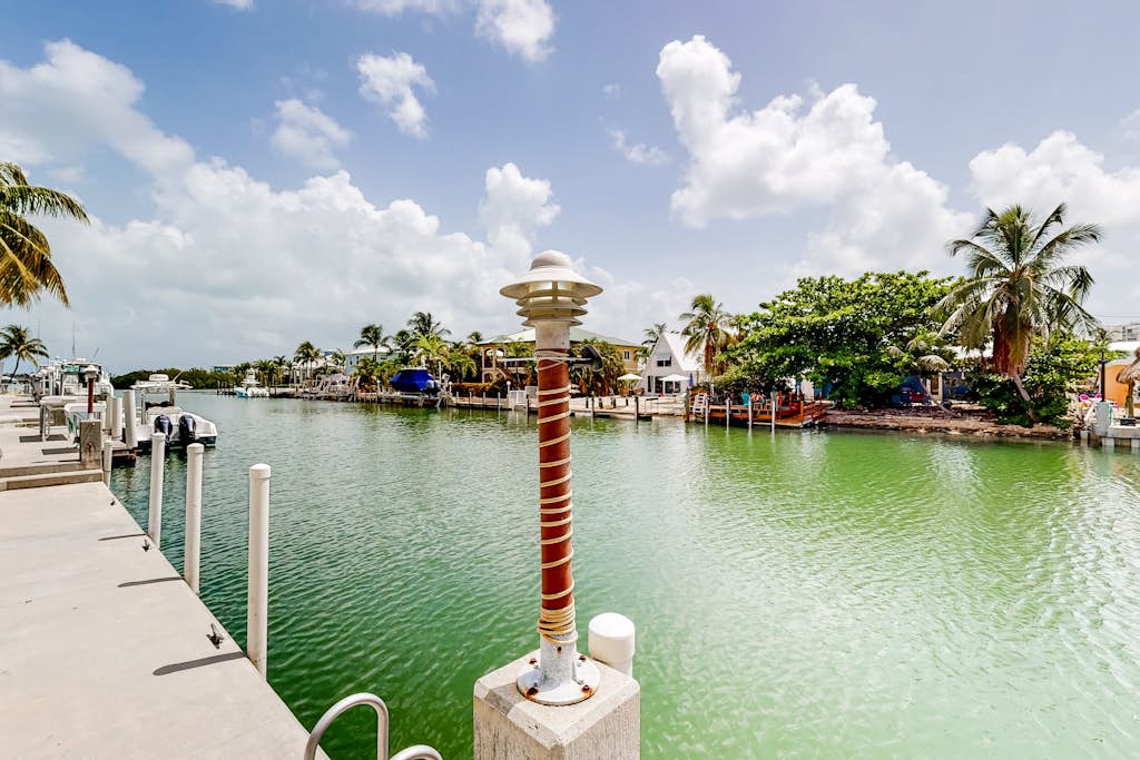 Waterfront home with 60-foot dock & beautiful patio - walk to beach & golf