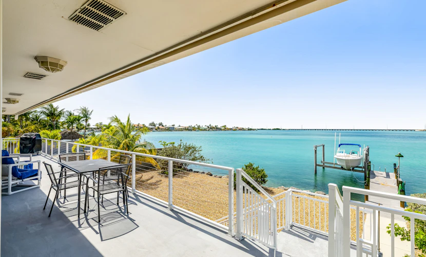 Dog-friendly beach escape with dock, furnished deck & bay views