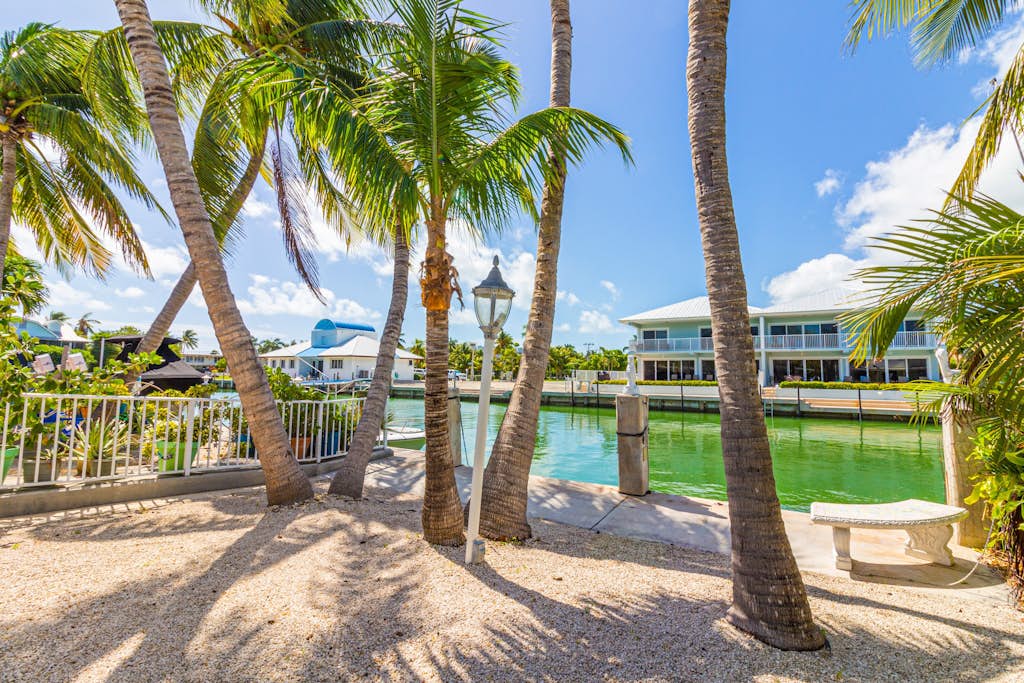 Waterfront home with 24-foot dock, shared pool, & beach access