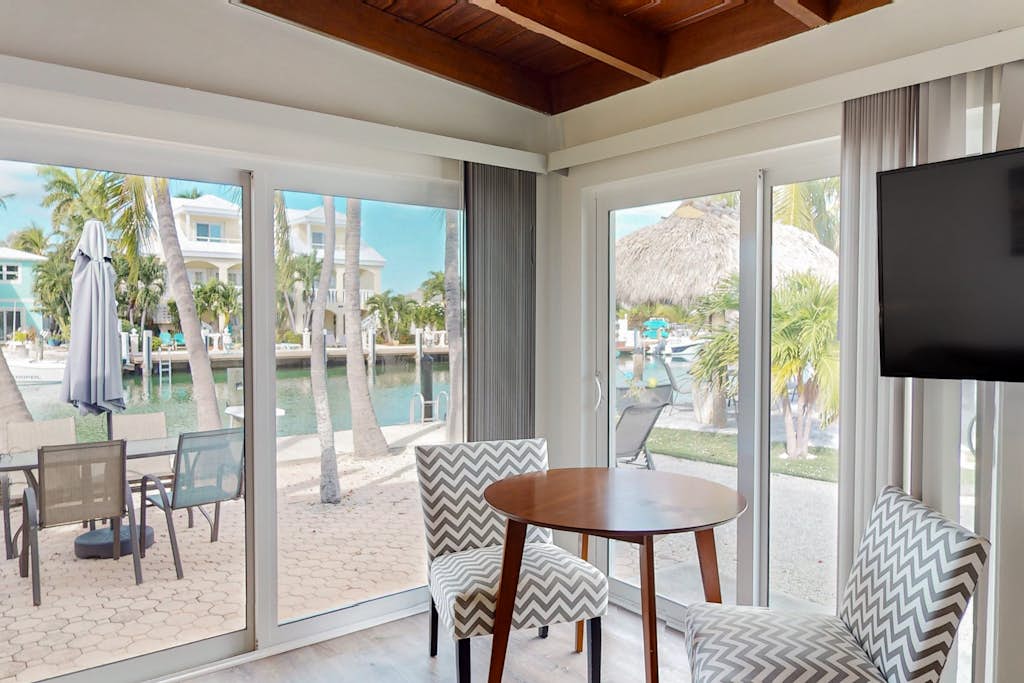 Beachy getaway with pool, water views, furnished patio, & dock access