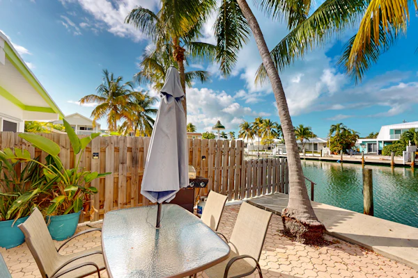 Beachy getaway with pool, water views, furnished patio, & dock access